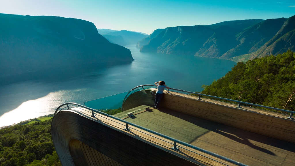Tourist enjoying fjord view on Stegastein viewpoint Norway