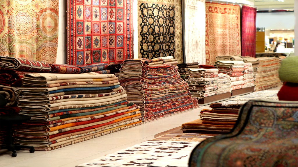 Large stacks of oriental Persian rugs in a store