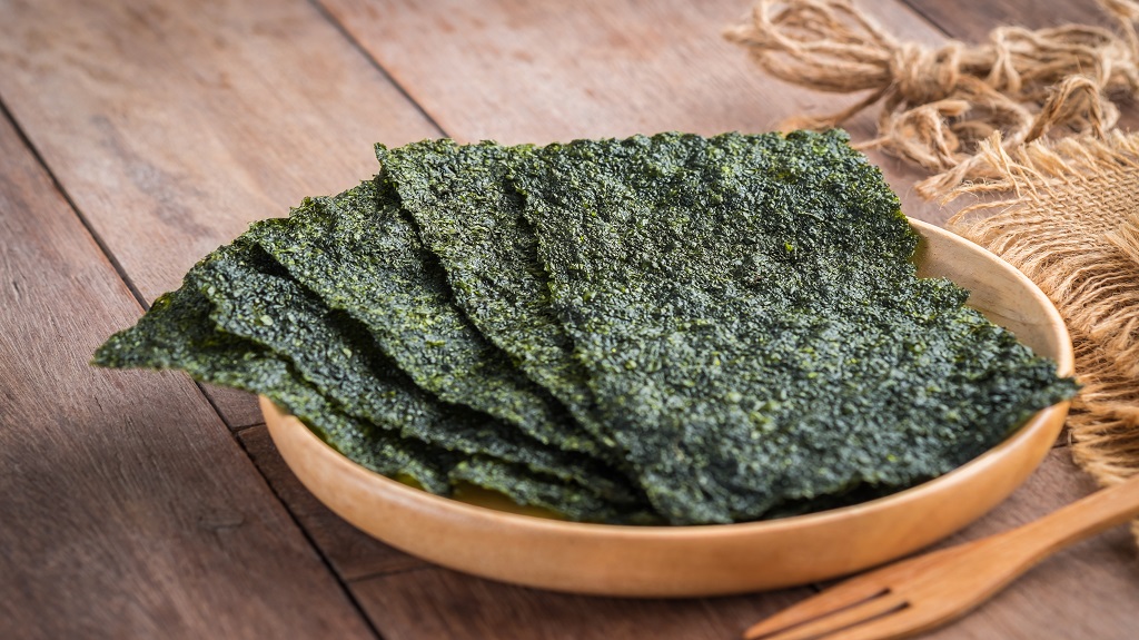 Crispy dried seaweed on wooden plate Crispy dried seaweed on wooden plate