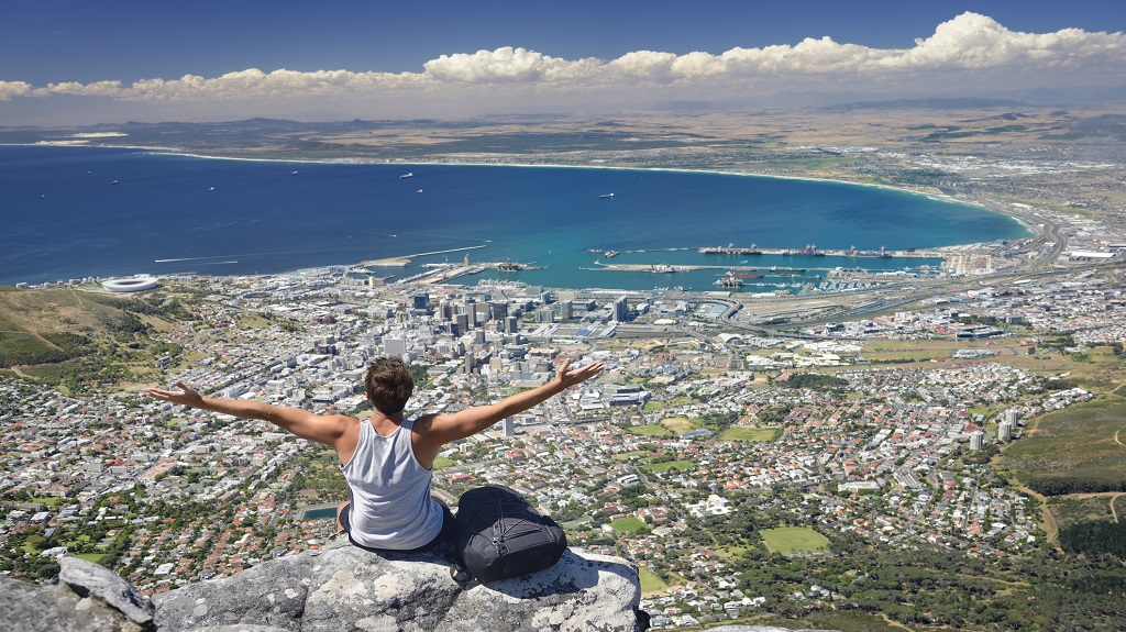 Tourist Hiker on Table Mountain overlooking Cape Town, South Africa Tourist Hiker on Table Mountain overlooking Cape Town, South Africa
