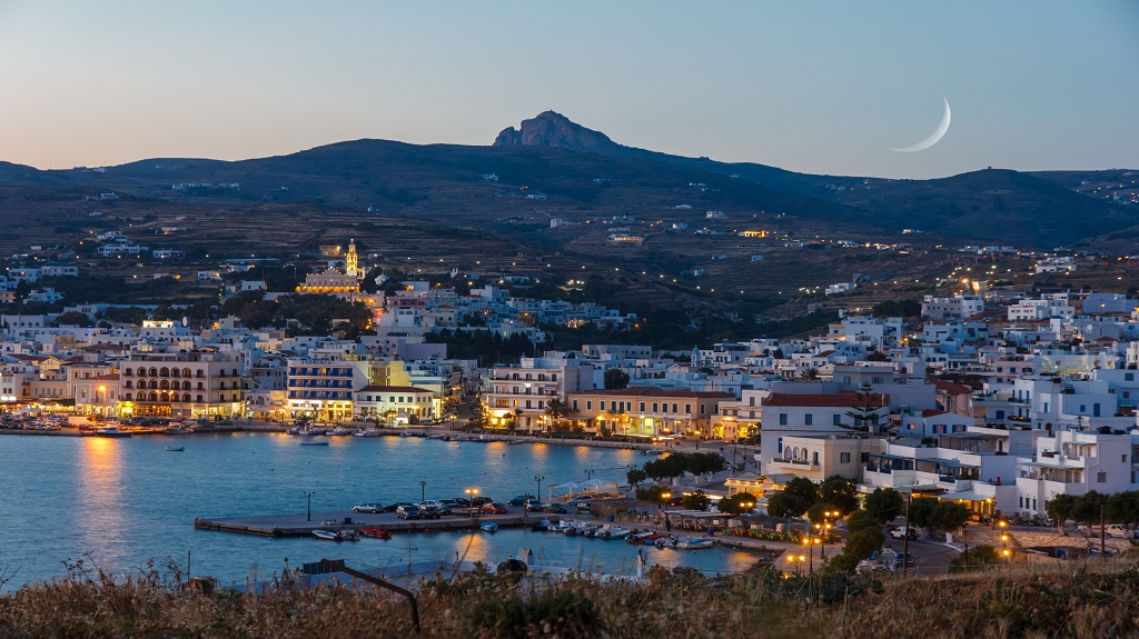 Tinos island at Cyclades, Greece in the evening with moon rising above the sky