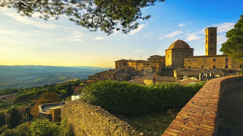 Tuscany, Volterra town skyline, church and trees on sunset. Ital